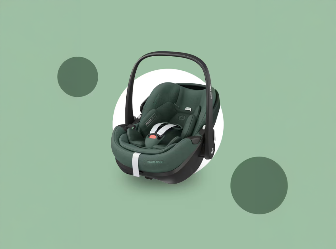 Green baby car seat on a green background