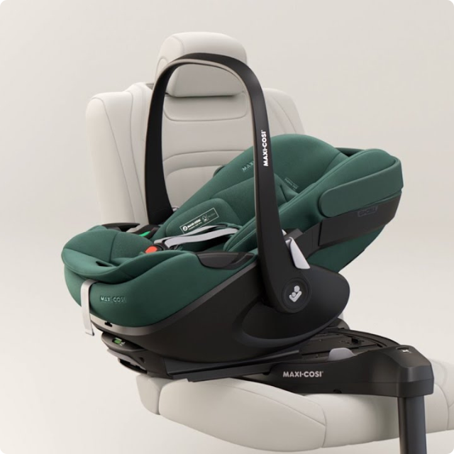 Green Maxi-Cosi car seat on a white background